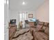 Relaxing Gathering room with brown leather couches at 17019 Avon Dive Ln, Wimauma, FL 33598
