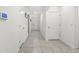Bright hallway with white doors and tiled floors at 17019 Avon Dive Ln, Wimauma, FL 33598