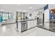 Modern kitchen with island and stainless steel appliances at 17019 Avon Dive Ln, Wimauma, FL 33598