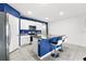 Modern kitchen with blue accent wall and island at 17019 Avon Dive Ln, Wimauma, FL 33598
