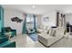 Spacious living room with a comfy sectional sofa and large window at 17019 Avon Dive Ln, Wimauma, FL 33598