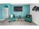 Teal sitting area with two accent chairs and a glass-top table at 17019 Avon Dive Ln, Wimauma, FL 33598