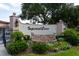 Imperial Cove entrance with lush landscaping and beautiful stonework at 19029 Us Highway 19 N # 26-304, Clearwater, FL 33764
