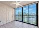 Bright lanai with tiled floor and sliding glass doors offering water views at 19029 Us Highway 19 N # 26-304, Clearwater, FL 33764