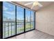 Spacious lanai with tiled floors and sliding glass doors, overlooks a parking area at 19029 Us Highway 19 N # 26-304, Clearwater, FL 33764