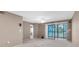 Spacious living room with balcony access and a ceiling fan at 19029 Us Highway 19 N # 26-304, Clearwater, FL 33764