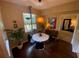 Small dining area with round table and four chairs, near a window at 2010 E Palm Ave # 15305, Tampa, FL 33605