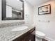 Bathroom with granite vanity, single sink, and toilet at 225 Country Club Dr # 1611, Largo, FL 33771