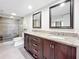 Double vanity bathroom with granite countertops and a large mirror at 225 Country Club Dr # 1611, Largo, FL 33771