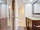 Bathroom with granite vanity, double sinks, and shower at 225 Country Club Dr # 1611, Largo, FL 33771