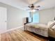 Cozy bedroom with ceiling fan, wood flooring and window coverings at 225 Country Club Dr # 1611, Largo, FL 33771