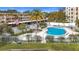 Relaxing kidney-shaped pool with surrounding patio and lounge chairs at 225 Country Club Dr # 1611, Largo, FL 33771