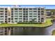 Condo building exterior with water view and lush landscaping at 225 Country Club Dr # 1611, Largo, FL 33771