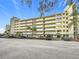 Condo building exterior with parking and landscaping at 225 Country Club Dr # 1611, Largo, FL 33771