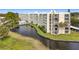 Condo building exterior showcasing its waterfront location and landscaping at 225 Country Club Dr # 1611, Largo, FL 33771