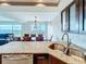 Kitchen with granite countertop, double sink, and view to dining area at 225 Country Club Dr # 1611, Largo, FL 33771