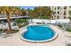 Inviting kidney-shaped pool with surrounding patio and lounge chairs at 225 Country Club Dr # 1611, Largo, FL 33771