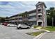 Brick condo building with parking and palm trees at 2461 Rhodesian Dr # 51, Clearwater, FL 33763