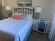 Bedroom featuring a bed, desk, and coastal decor at 2465 Northside Dr # 1203, Clearwater, FL 33761