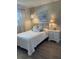 Bright bedroom with a comfortable queen-size bed and an adjacent nightstand at 2465 Northside Dr # 1203, Clearwater, FL 33761