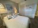 Guest bedroom with a white bed and calming decor at 2465 Northside Dr # 1203, Clearwater, FL 33761