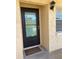 Inviting condo entry with a black door and welcome mat at 2465 Northside Dr # 1203, Clearwater, FL 33761