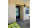 Condo entrance featuring a teal glass door and light colored stucco at 2465 Northside Dr # 1203, Clearwater, FL 33761