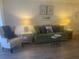 Living room featuring a green sofa and two armchairs at 2465 Northside Dr # 1203, Clearwater, FL 33761