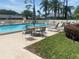 Community pool with lounge chairs and a table with umbrellas, great for relaxation at 2465 Northside Dr # 1203, Clearwater, FL 33761
