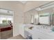 Elegant bathroom boasts a double vanity, large mirror, and a glimpse of the bedroom at 2850 Deer Run, Tarpon Springs, FL 34688