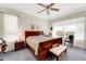 Spacious bedroom with a wooden sleigh bed, ample natural light, and a cozy sitting area at 2850 Deer Run, Tarpon Springs, FL 34688