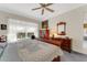 Serene bedroom with pool view, featuring a wooden sleigh bed and a rocking chair at 2850 Deer Run, Tarpon Springs, FL 34688