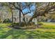 Landscaped yard with large oak trees and lush grass at 2850 Deer Run, Tarpon Springs, FL 34688