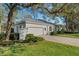 White house with attached garage and paver driveway at 2850 Deer Run, Tarpon Springs, FL 34688
