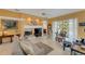 Living room with fireplace, large windows, and access to pool area at 2850 Deer Run, Tarpon Springs, FL 34688