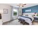 Relaxing bedroom with calming blue accent wall and comfortable bedding at 32603 Turtle Grace Loop, Wesley Chapel, FL 33545