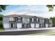 Three-unit townhome building showcasing attached garages and curb appeal at 32603 Turtle Grace Loop, Wesley Chapel, FL 33545