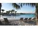 Relaxing beach area with lounge chairs by the lagoon at 32603 Turtle Grace Loop, Wesley Chapel, FL 33545