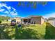 Sunny backyard with grassy area and a covered patio at 3407 Walden Reserve Dr, Plant City, FL 33566
