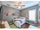 Cheerful bedroom with a bed, plenty of wall decor, and hardwood floors at 3407 Walden Reserve Dr, Plant City, FL 33566