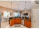 Modern kitchen with an island, wood cabinets, granite countertops, and stainless steel appliances at 3407 Walden Reserve Dr, Plant City, FL 33566