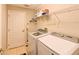 Functional laundry room with washer, dryer, and storage shelving at 3407 Walden Reserve Dr, Plant City, FL 33566
