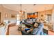 Open living room showcasing a large sectional sofa, coffee table, and views into the kitchen and dining area at 3407 Walden Reserve Dr, Plant City, FL 33566