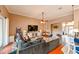 Comfortable living room with hardwood floors, sectional sofa, and a view to the kitchen at 3407 Walden Reserve Dr, Plant City, FL 33566