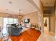 Relaxing living room featuring hardwood floors, a large sectional sofa, and a big TV at 3407 Walden Reserve Dr, Plant City, FL 33566