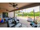 Relaxing covered patio featuring comfortable seating and a view of the backyard at 3407 Walden Reserve Dr, Plant City, FL 33566