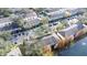 Aerial view of a community of townhouses with a pool and lake at 3529 High Hampton Cir, Tampa, FL 33610