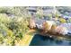 Aerial view showing townhouses nestled in a wooded area near a lake at 3529 High Hampton Cir, Tampa, FL 33610