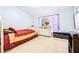 Light-filled bedroom with a double bed, dresser, and large window at 3529 High Hampton Cir, Tampa, FL 33610