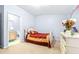 Bright bedroom with a double bed, dresser, and en-suite bathroom at 3529 High Hampton Cir, Tampa, FL 33610